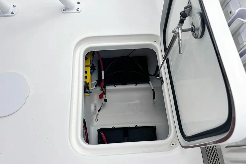 Slide: The Image of Open hatch of 2026 Sea Pro 230 Bay boat showing internal wiring and components. - 40