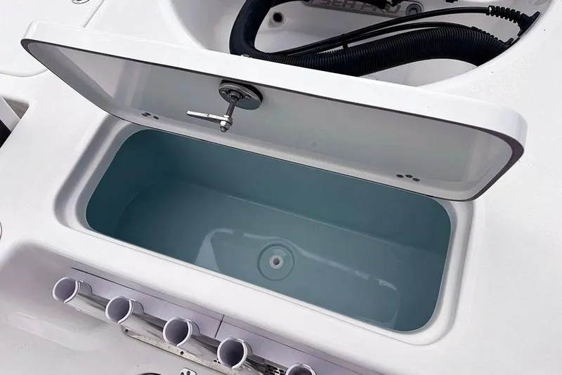 Slide: The Image of 2026 Sea Pro 230 Bay boat livewell with open lid and rod holders. - 44