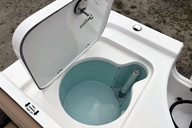 Slide: The Image of Livewell compartment on a 2026 Sea Pro 230 Bay boat, open lid view. - 45