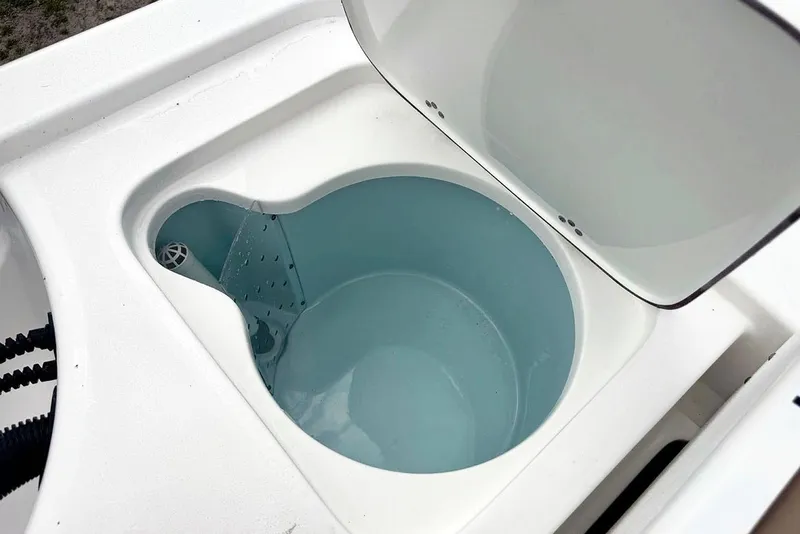 Slide: The Image of Livewell compartment on a 2026 Sea Pro 230 Bay boat, open lid, filled with water. - 46