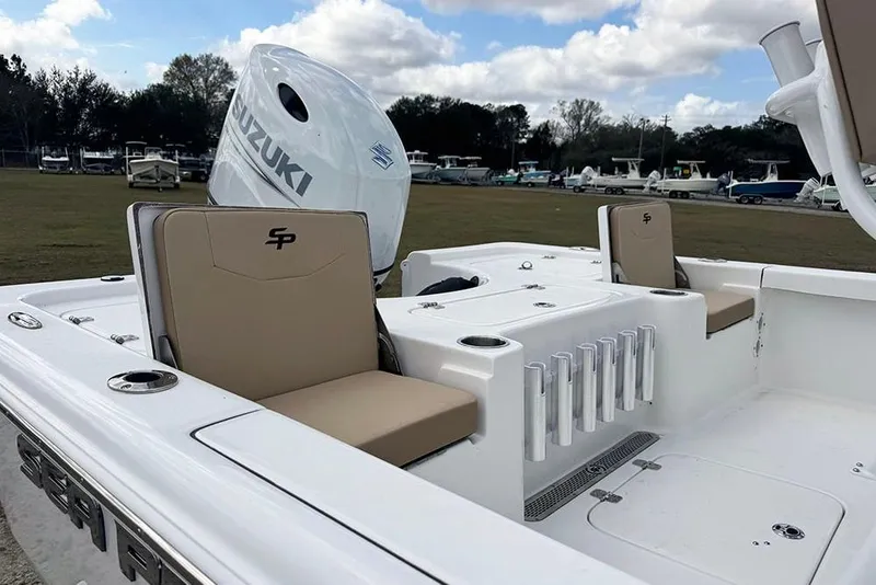 Slide: The Image of 2026 Sea Pro 230 Bay boat interior with Suzuki engine, featuring beige seating and rod holders. - 49