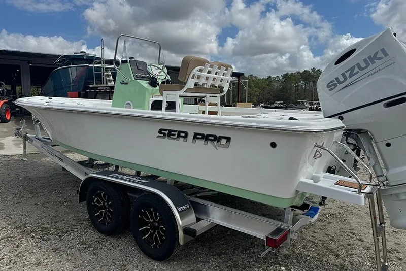 Slide: The Image of 2026 Sea Pro 230 Bay boat on trailer with Suzuki engine, parked outdoors. - 6