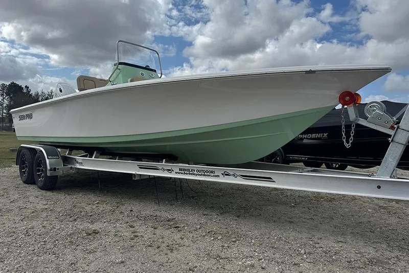Slide: The Image of 2026 Sea Pro 230 Bay boat on trailer under cloudy sky. - 8