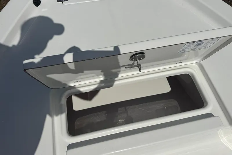 Slide: The Image of 2026 Sea Pro 172 Bay boat storage compartment with open lid and visible shadow. - 14