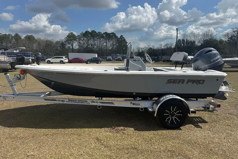 Slide: The Image of 2026 Sea Pro 172 Bay boat on trailer, parked outdoors under cloudy sky. - 2