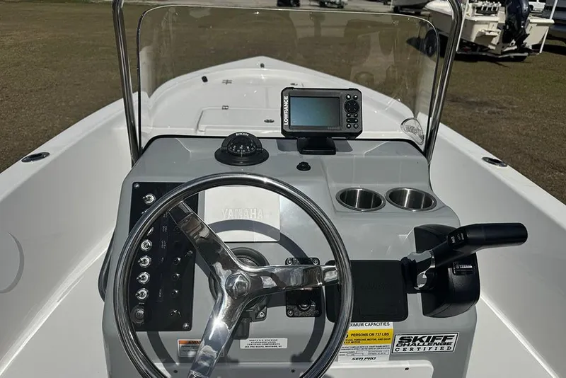 Slide: The Image of 2026 Sea Pro 172 Bay boat dashboard with steering wheel, compass, and navigation system. - 21