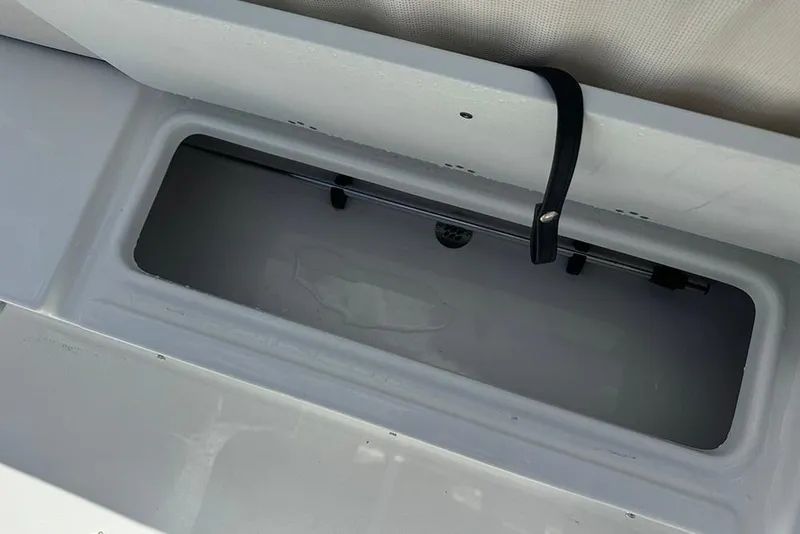 Slide: The Image of Livewell compartment in a 2026 Sea Pro 172 Bay boat, featuring a secure latch. - 26