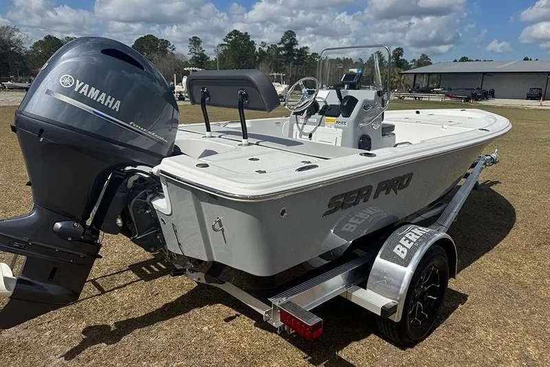 Slide: The Image of 2026 Sea Pro 172 Bay boat with Yamaha engine on trailer, parked outdoors. - 6