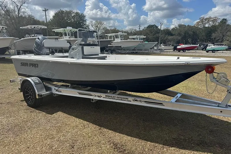 Slide: The Image of 2026 Sea Pro 172 Bay boat on trailer, parked outdoors under a cloudy sky. - 9
