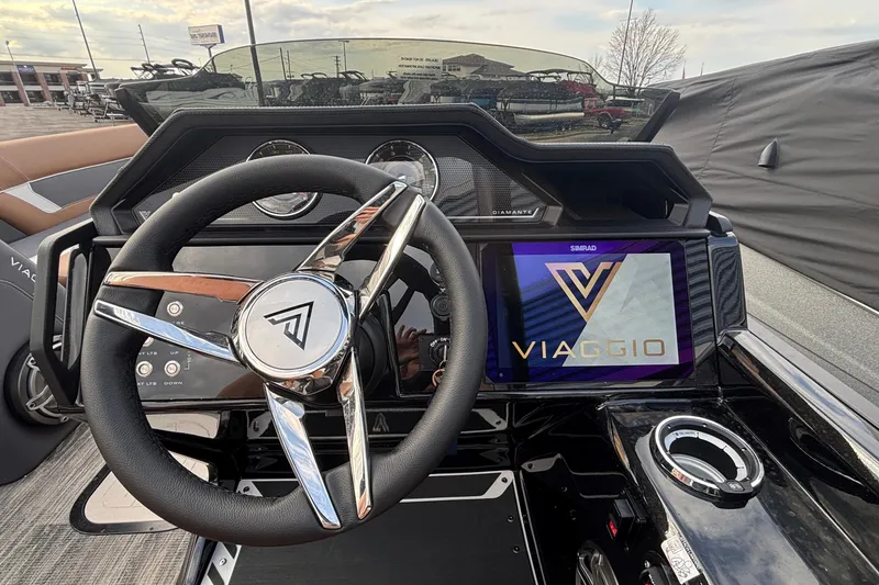 Slide: The Image of Steering wheel and dashboard of 2026 Viaggio Diamante U 26 boat, featuring digital display. - 11