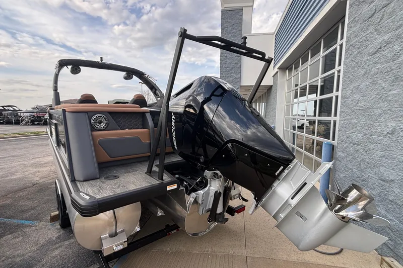 Slide: The Image of 2026 Viaggio Diamante U 26 boat with powerful outboard motor, docked near a modern building. - 2