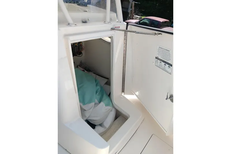 Slide: The Image of 2014 Cobia 296 Center Console boat interior storage compartment with open hatch. - 12