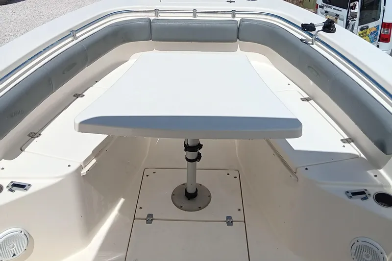Slide: The Image of 2014 Cobia 296 Center Console boat interior with seating and table. - 32