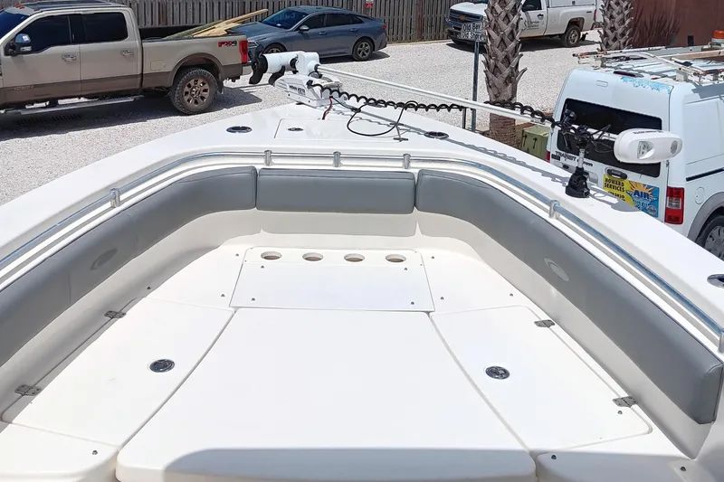 Slide: The Image of 2014 Cobia 296 Center Console boat with spacious seating and fishing rod holders. - 33