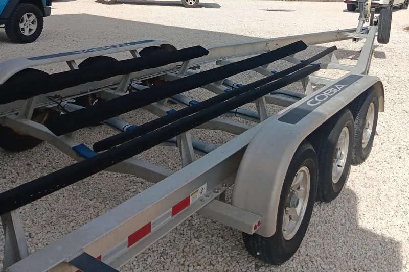 Slide: The Image of Trailer for 2014 Cobia 296 Center Console boat on gravel surface. - 37