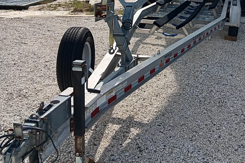 Slide: The Image of Trailer for 2014 Cobia 296 Center Console on gravel surface. - 38