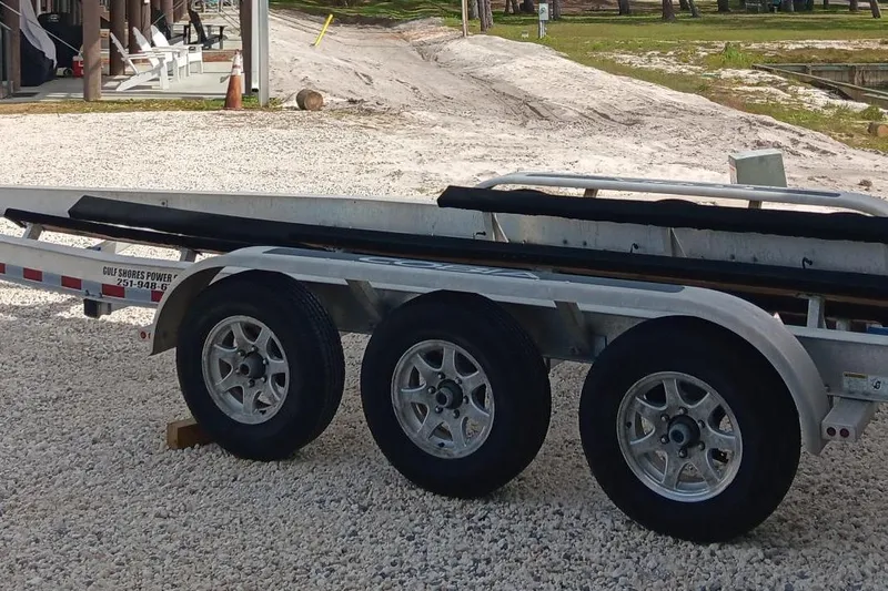 Slide: The Image of Triple-axle boat trailer on gravel, suitable for 2014 Cobia 296 Center Console. - 40