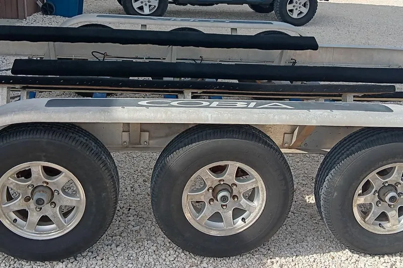 Slide: The Image of Trailer for 2014 Cobia 296 Center Console boat with triple axles. - 41