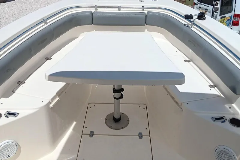 Slide: The Image of 2014 Cobia 296 Center Console boat interior with seating and table. - 45