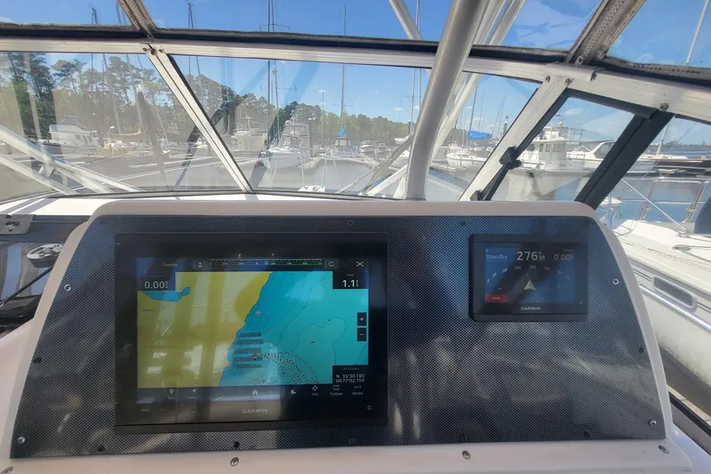 Slide: The Image of Grady-White Marlin 300 cockpit with navigation screens, docked at marina, 2004 model. - 10