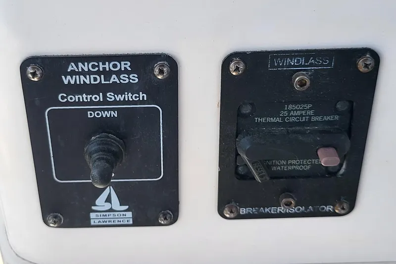 Slide: The Image of 2004 Grady-White Marlin 300 anchor windlass control and circuit breaker panel. - 13