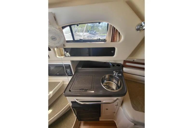 Slide: The Image of 2004 Grady-White Marlin 300 boat interior with kitchenette and sink. - 14