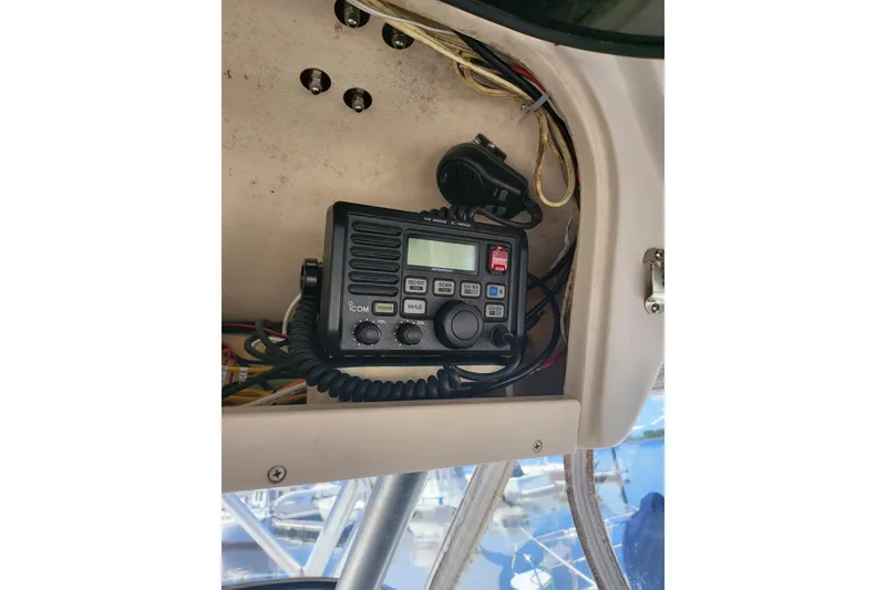 Slide: The Image of 2004 Grady-White Marlin 300 boat radio equipment with wiring and controls. - 16