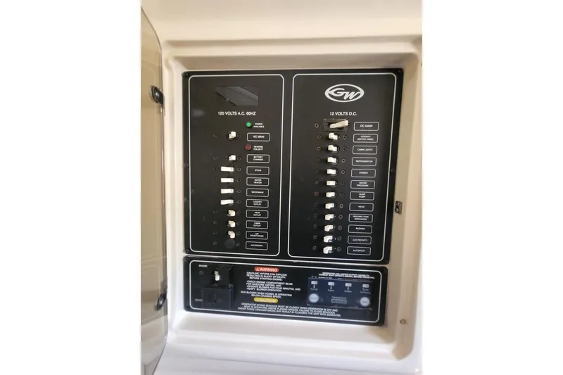 Slide: The Image of Electrical panel of 2004 Grady-White Marlin 300 boat, featuring AC and DC switches. - 18
