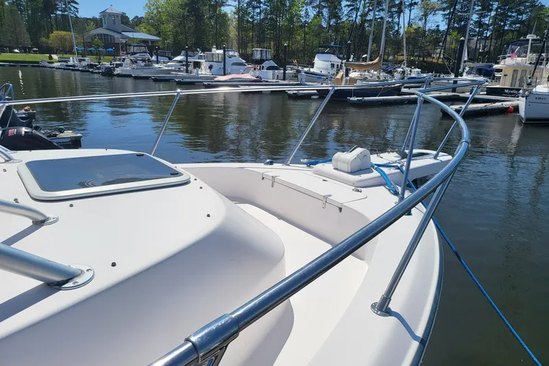 Slide: The Image of 2004 Grady-White Marlin 300 boat docked at a marina with other vessels. - 20