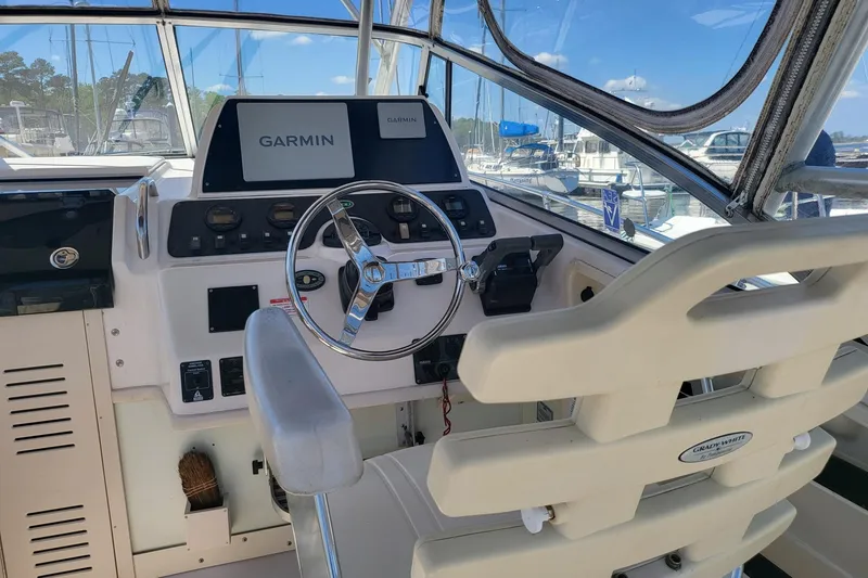 Slide: The Image of 2004 Grady-White Marlin 300 helm with Garmin navigation system, docked at marina. - 21