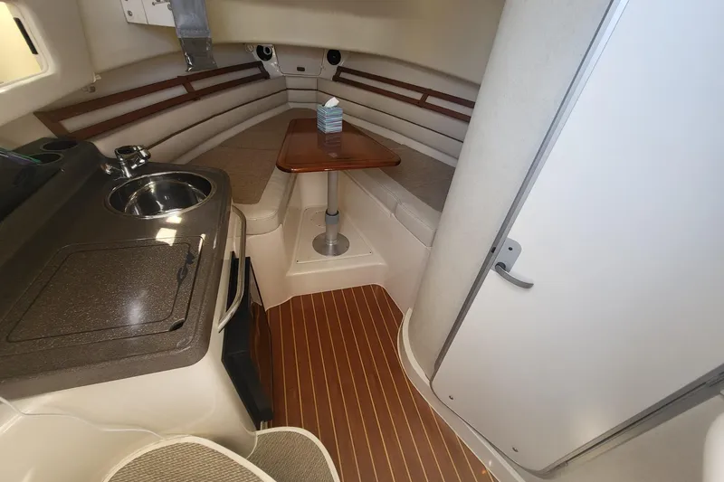 Slide: The Image of 2004 Grady-White Marlin 300 cabin interior with kitchenette and seating area. - 22