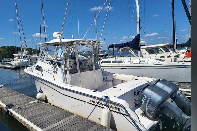 Slide: The Image of 2004 Grady-White Marlin 300 boat docked at a marina with clear skies. - 24