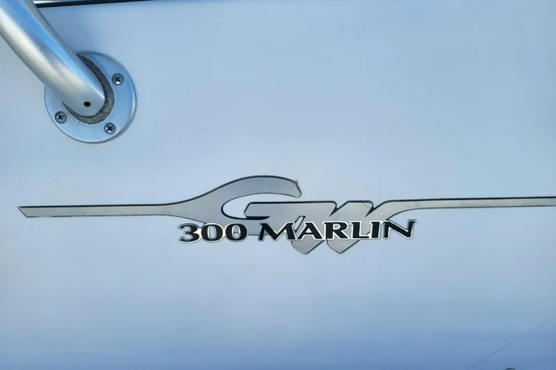Slide: The Image of Grady-White Marlin 300 logo on 2004 boat, featuring sleek design elements. - 27