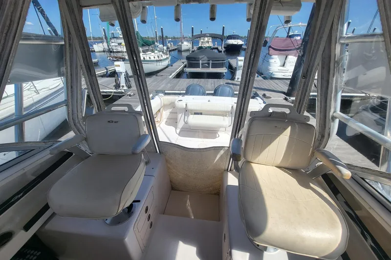 Slide: The Image of 2004 Grady-White Marlin 300 boat interior with dual seats at marina. - 3