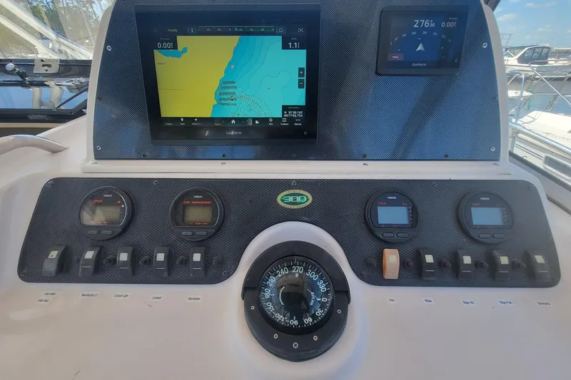 Slide: The Image of Dashboard of a 2004 Grady-White Marlin 300 boat with navigation instruments. - 5
