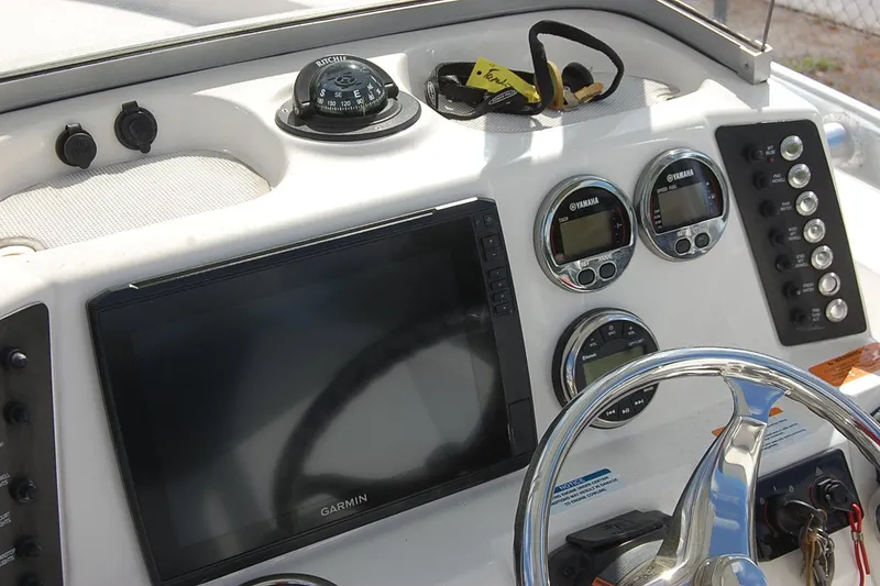 Slide: The Image of 2019 Robalo 226 Cayman boat dashboard with Garmin display and Yamaha gauges. - 10