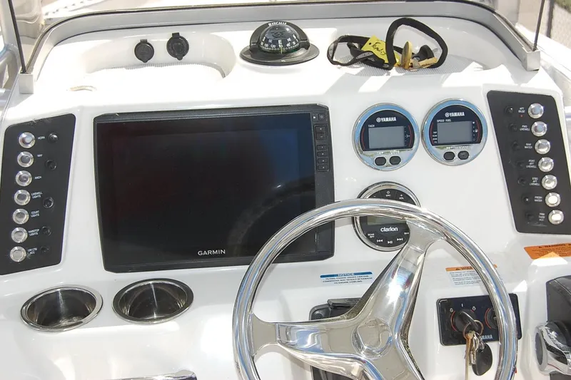 Slide: The Image of 2019 Robalo 226 Cayman boat dashboard with Garmin display and Yamaha gauges. - 11