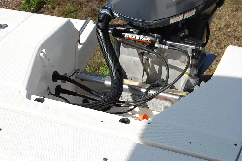 Slide: The Image of 2019 Robalo 226 Cayman boat engine and steering system close-up. - 13
