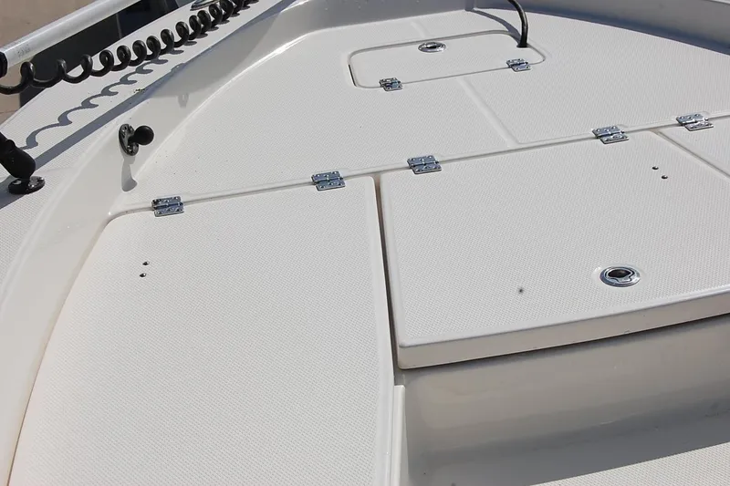 Slide: The Image of 2019 Robalo 226 Cayman boat deck with storage compartments and coiled cable. - 15