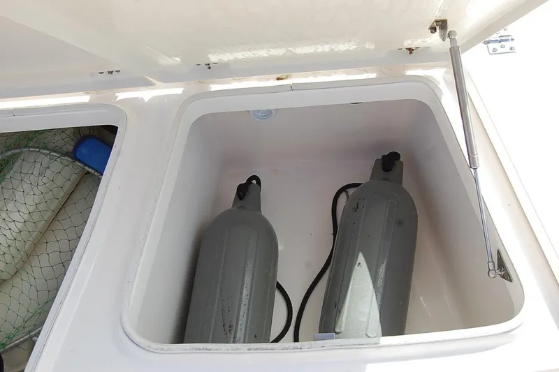 Slide: The Image of Storage compartment on 2019 Robalo 226 Cayman boat with fenders and netting. - 18