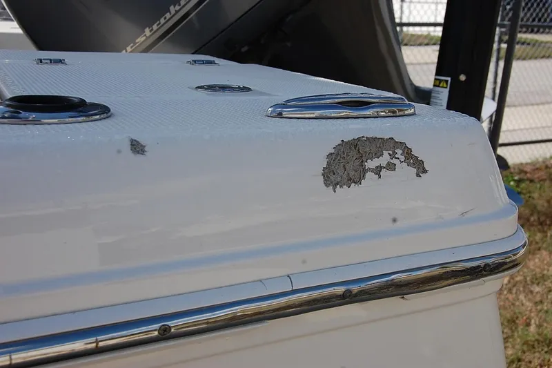 Slide: The Image of 2019 Robalo 226 Cayman boat with visible hull damage near the stern. - 3