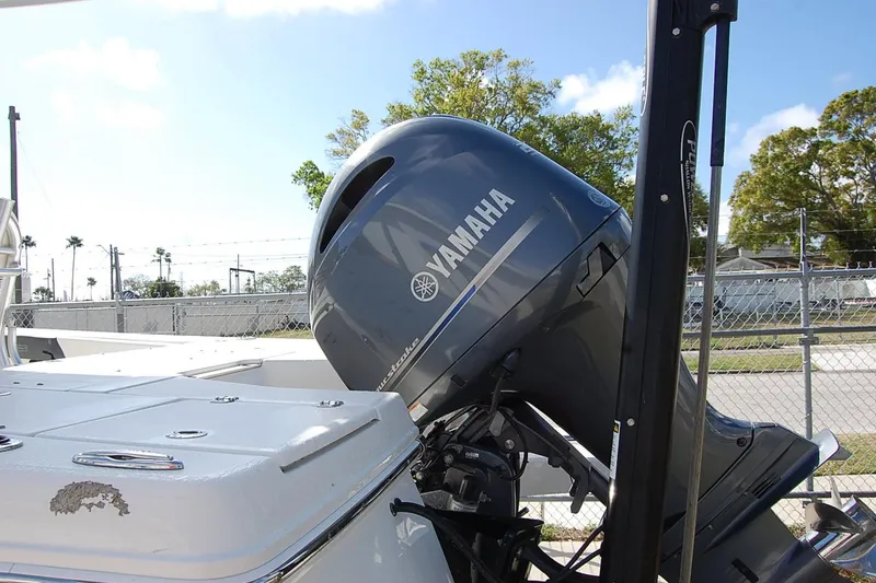 Slide: The Image of 2019 Robalo 226 Cayman boat with Yamaha outboard motor, parked outdoors. - 4