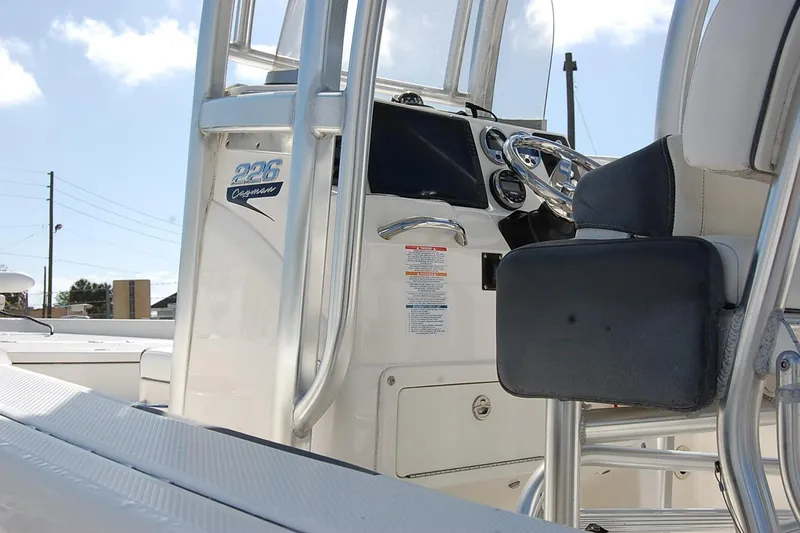 Slide: The Image of 2019 Robalo 226 Cayman boat interior with steering console and seating. - 7