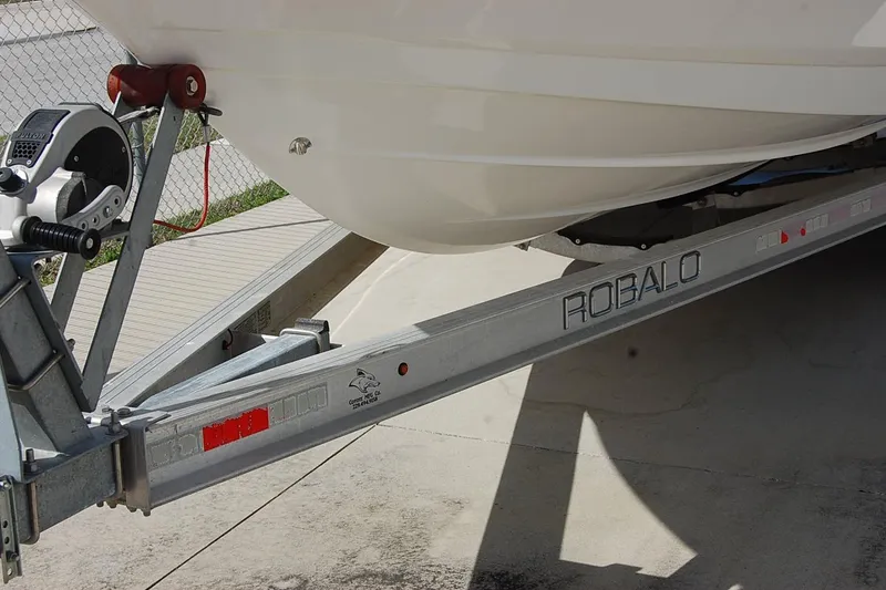 Slide: The Image of 2019 Robalo 226 Cayman boat on trailer, close-up view. - 8