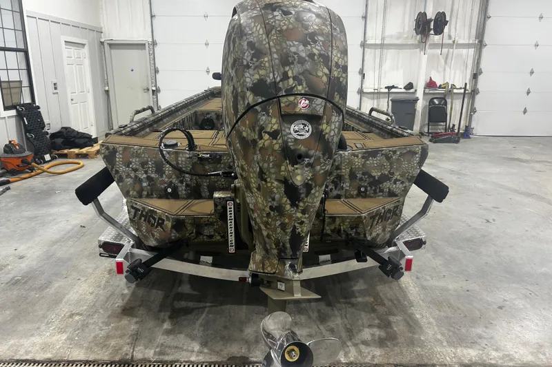 Slide: The Image of Camouflage-patterned 2026 Thor Lake Hammer CC 1900 boat in a garage setting. - 3