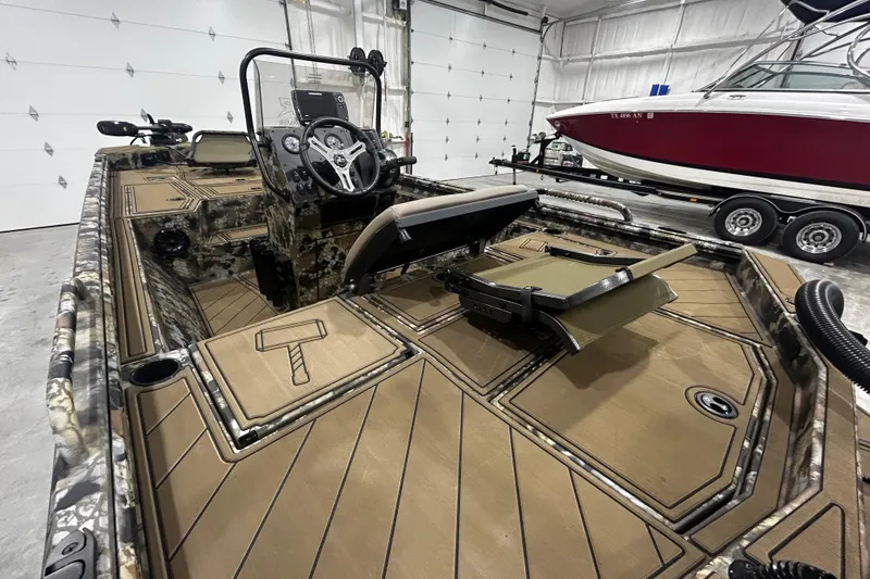 Slide: The Image of 2026 Thor Lake Hammer CC 1900 boat interior with camouflage design in a garage setting. - 4