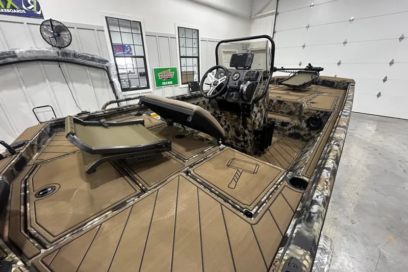 Slide: The Image of 2026 Thor Lake Hammer CC 1900 boat interior with camouflage design and modern controls. - 7