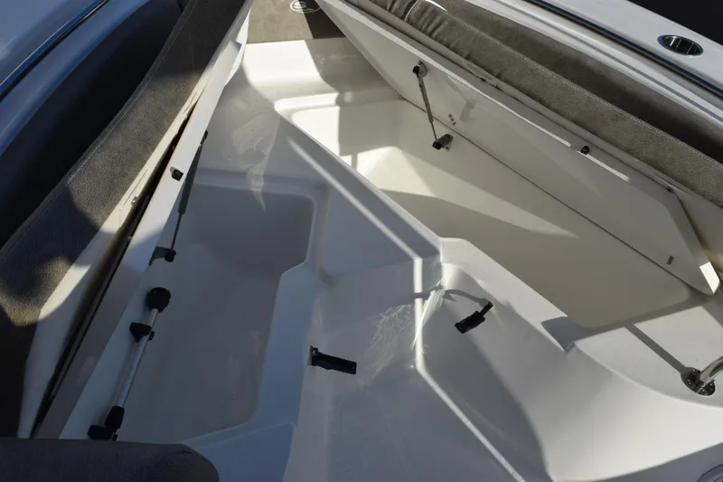 Slide: The Image of 2026 Sea Hunt Ultra 219 boat interior storage compartment with open hatch. - 14