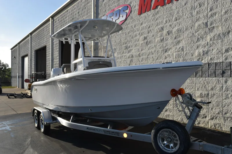 Slide: The Image of 2026 Sea Hunt Ultra 219 boat on trailer outside a marine dealership. - 2