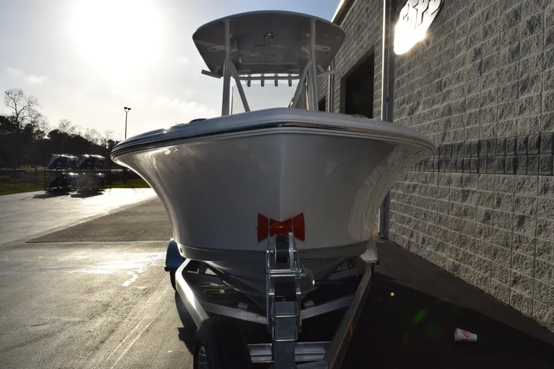 Slide: The Image of 2026 Sea Hunt Ultra 219 boat on trailer, parked outside a building. - 3